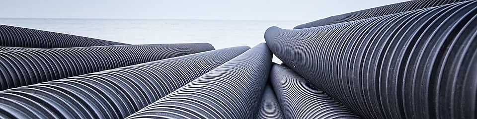 Black, corrugated HDPE plastic pipe that pipe extruders would make