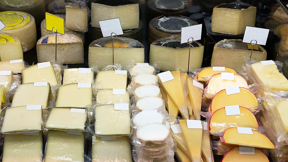 A shelf of bulk cheese using lldpe plastic film wrap