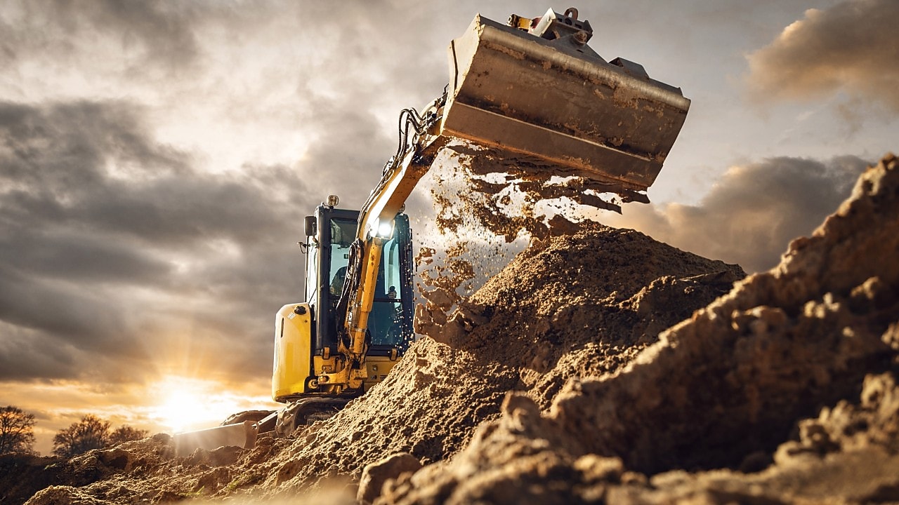 Off-highway operations featuring a bulldozer moving a large dirt pile.