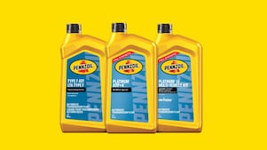 Lineup of three different bottles of Shell Pennzoil automatic transmission fluid.
