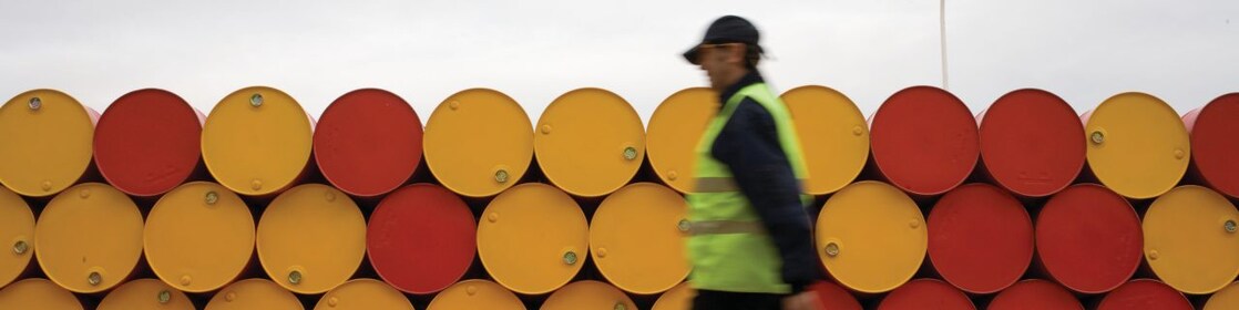 Man walking infront of barrels