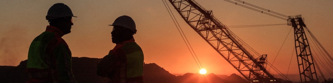 two men talking to each other on a construction site