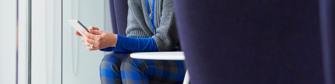Woman using mobile phone in office