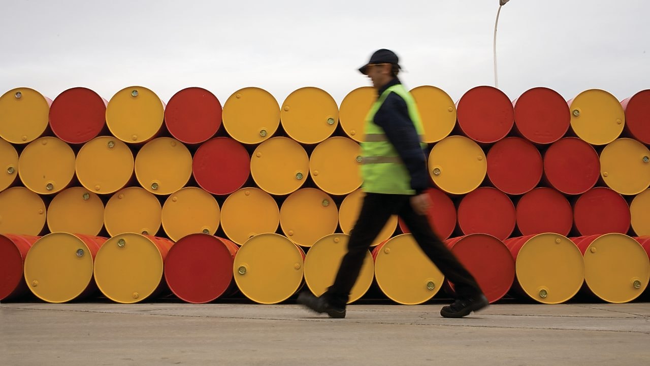 an walking infront of barrels