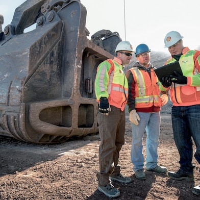 Employees discussing about project on site