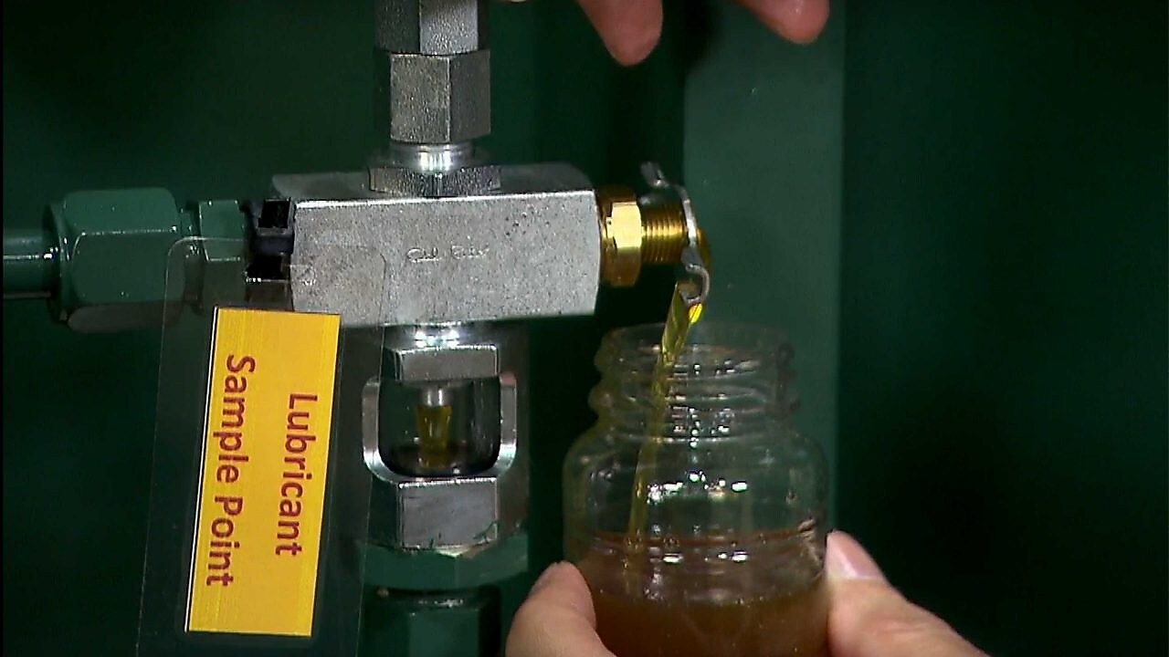 Oil flowing into sample bottle