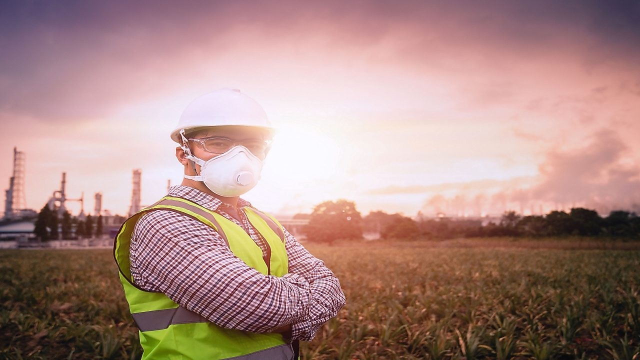 Woman in distribution plant with facemask