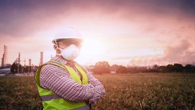 Woman in distribution plant with facemask