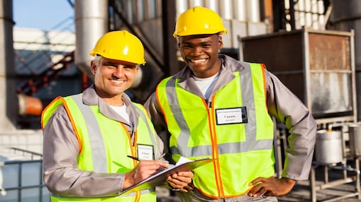 Two workers in a facility reviewing documents