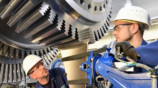Two engineers working on a turbine