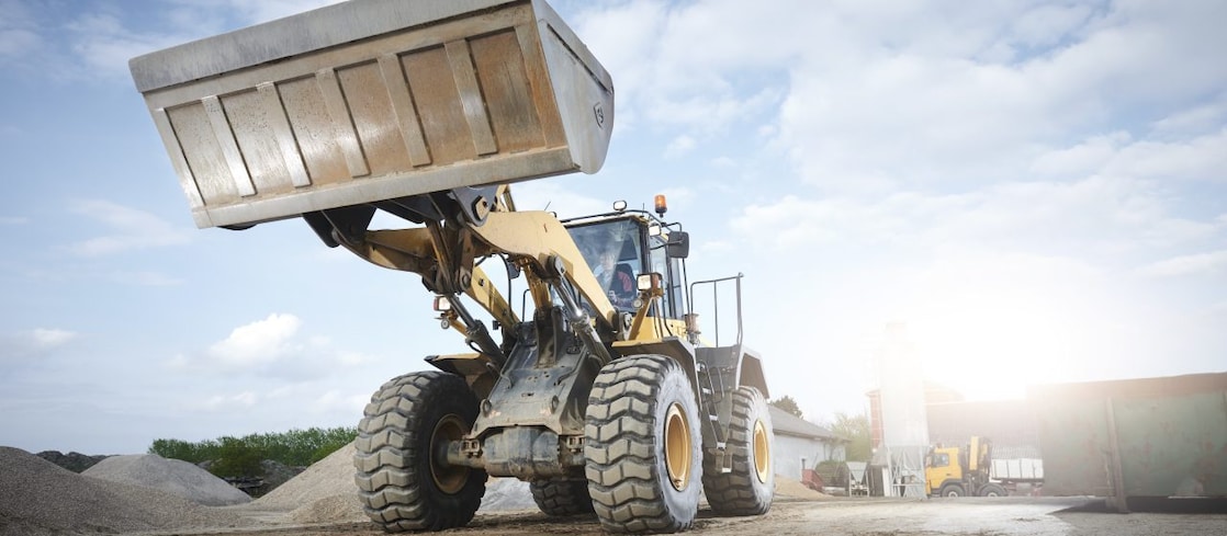 Excavator moving sand