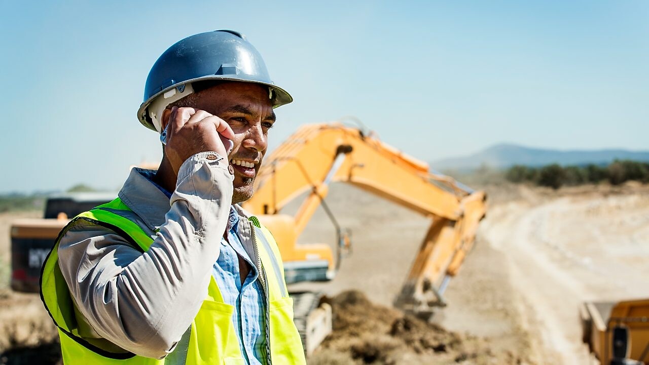 Architect using phone at quarry