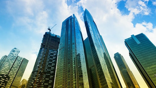 Cranes and clouds above a skyscraper in construction