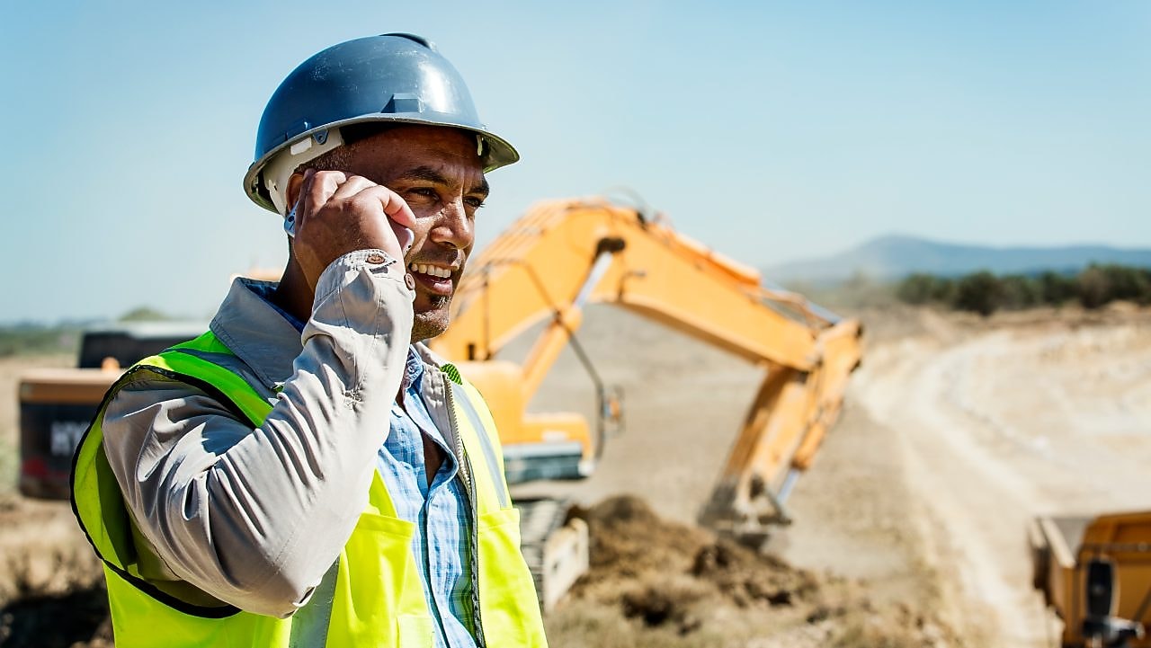 Architect using phone at quarry