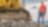 Shell Construction worker standing next to tracked excavator