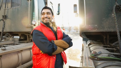 Driver standing outside truck