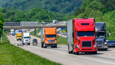 Commercial trucks traveling on a highway