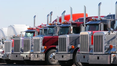 Fleet of commercial trucks parked in a row