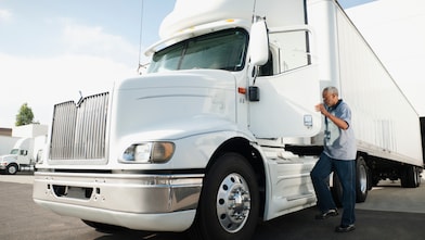 Commercial truck driver stepping out of a semi-truck