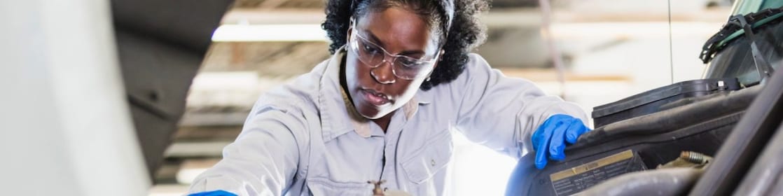 Woman working on truck engine