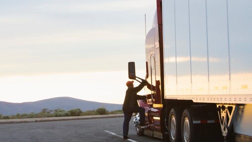 Man climbing the truck cabin