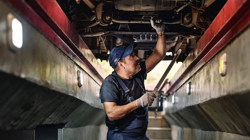 Man working on a truck part.
