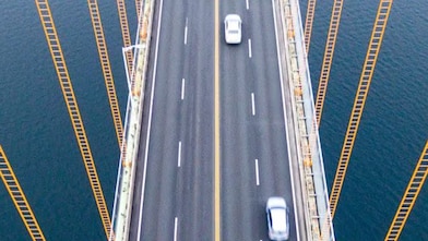 Cars driving across suspension bridge