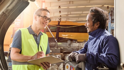 Shop workers reviewing paperwork