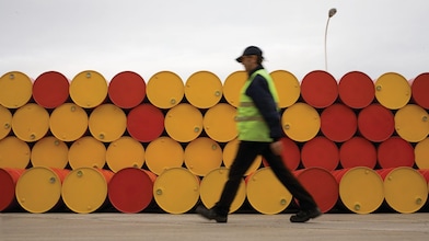 Man walking infront of barrels