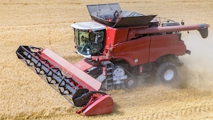 Combine harvester in field