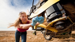 Female farmer working with agriculture equipment