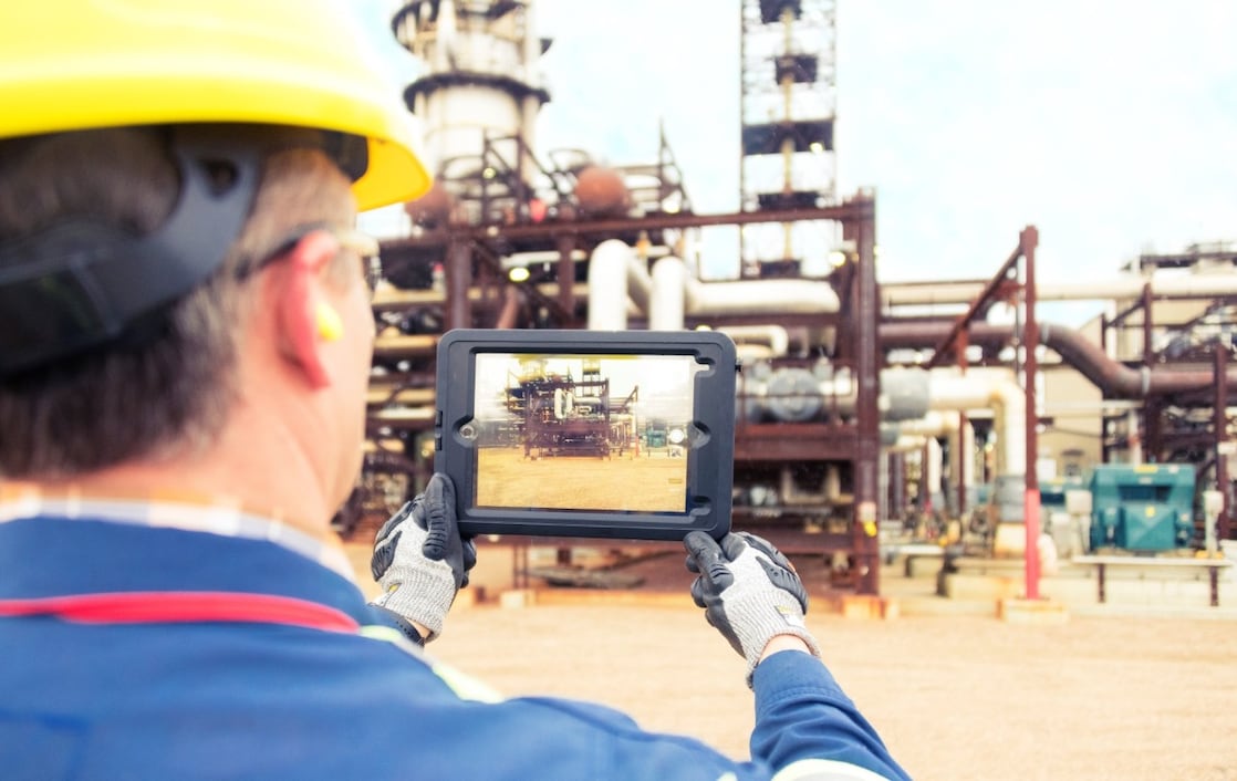 Technician assessing the site and capturing images on a tablet.