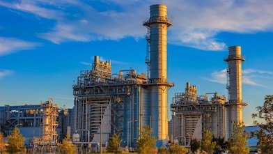 A power engineer maintains an industrial turbine to keep it operating efficiently.