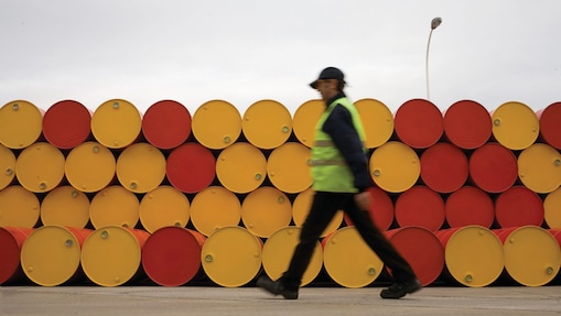 Man walking infront of barrels