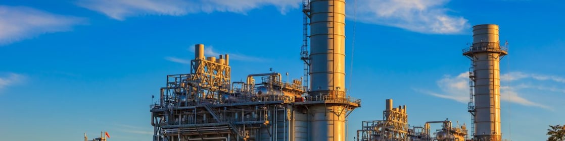 A power engineer maintains an industrial turbine to keep it operating efficiently.