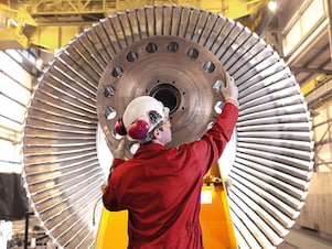 man repairing turbines