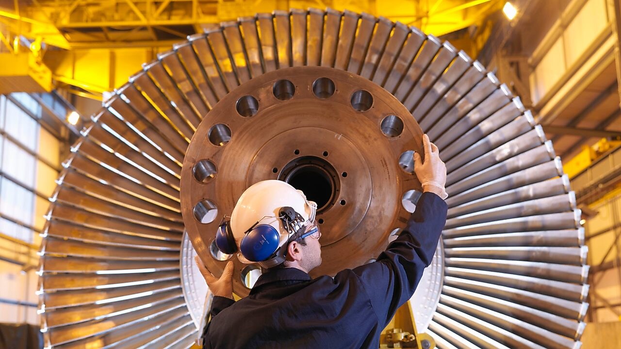 An engineer examines turbine parts to help ensure it will deliver peak performance.