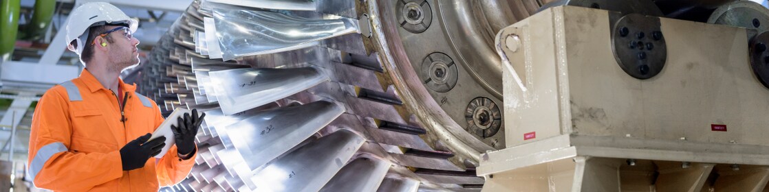 Power engineer next to turbines