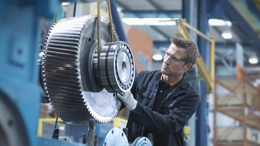 A Shell expert inspects and monitors a piece of machinery