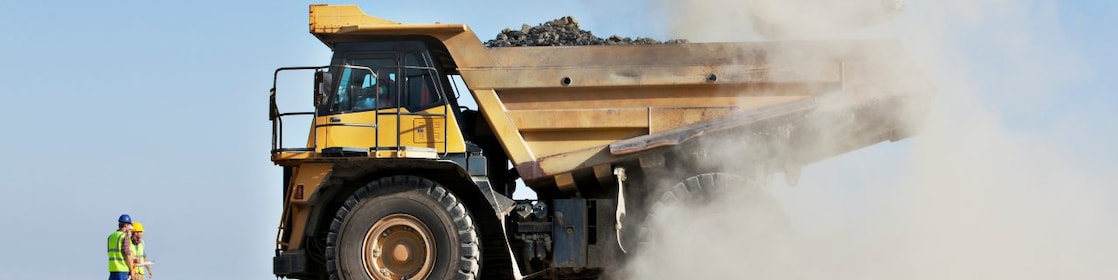 A Shell mining truck is loaded on site as Shell workers look on