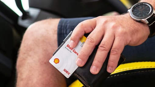 Driver holding Shell Card against wallet