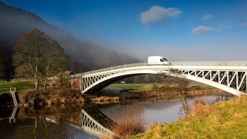 Commercial Fleet vehicle crossing a bridge.