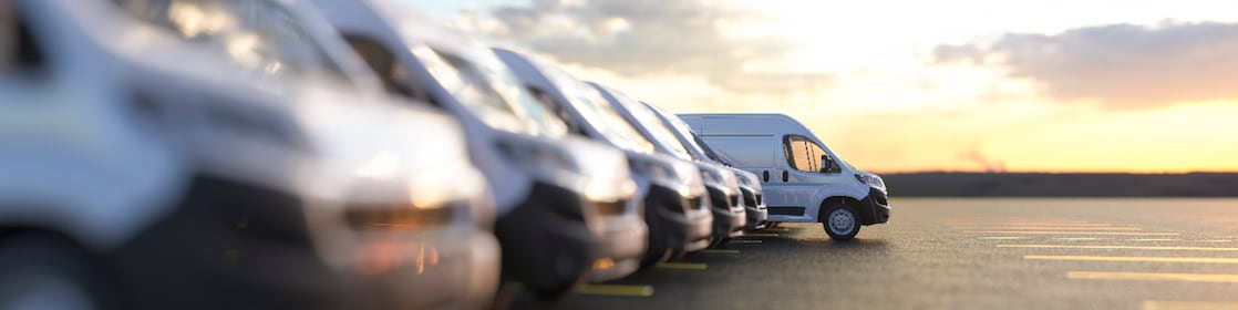 A row of cars parked in a parking lot