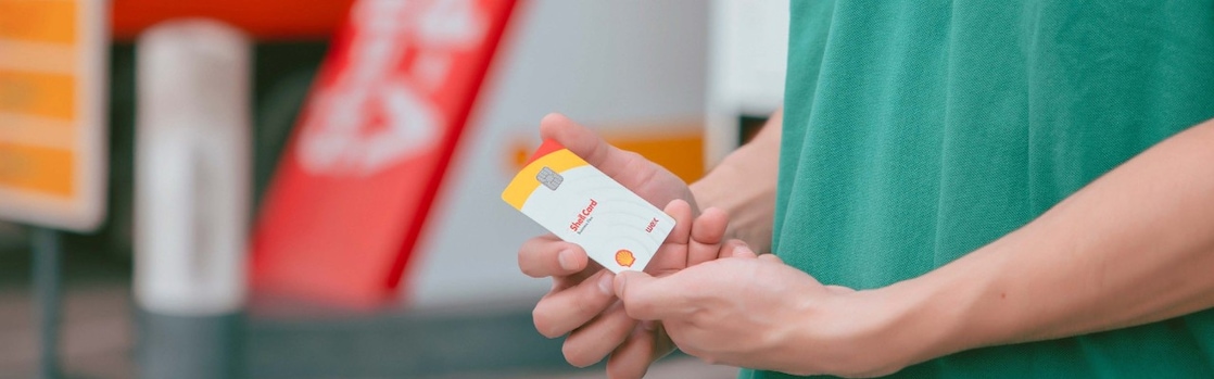 Driver near Shell gas station holding card