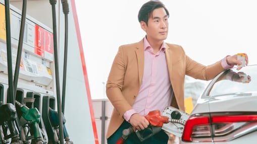 Driver pumping gas at Shell station