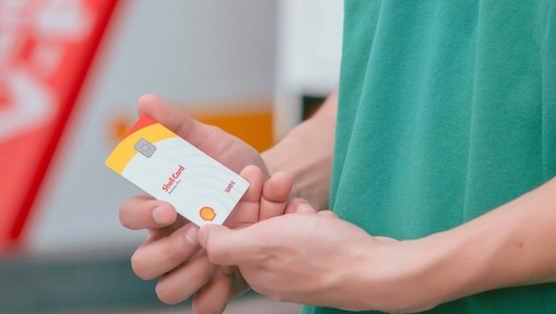 Driver near Shell gas station holding card