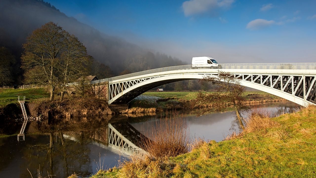 Commercial van crossing bridge