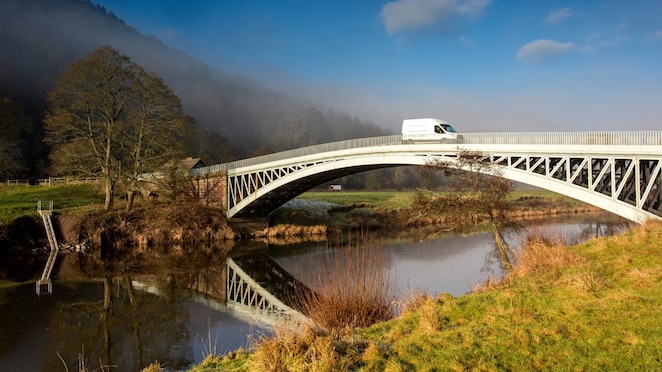 Commercial van crossing bridge
