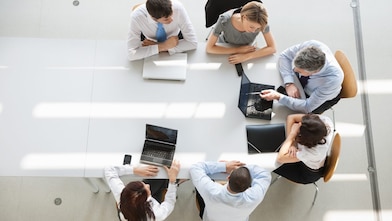 Employees meeting on a boardroom table