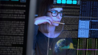 Businesswoman looking at data on a screen